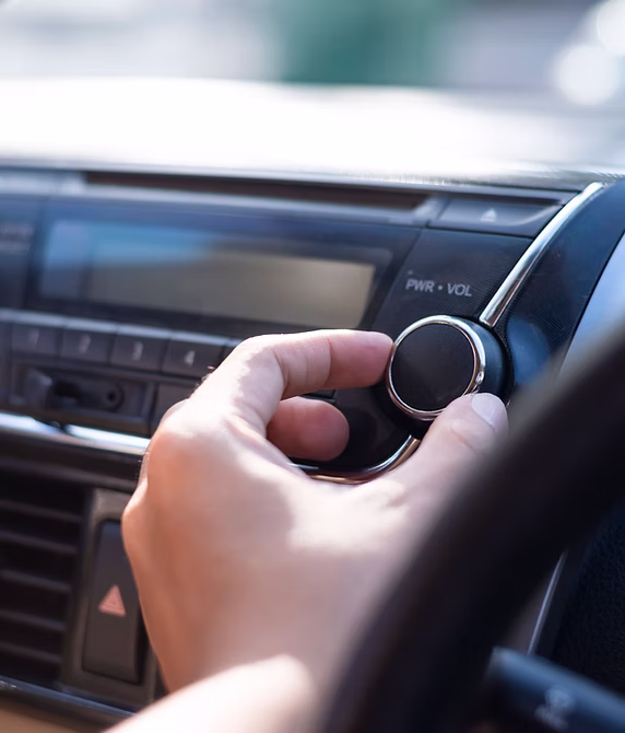Hand tuning a car radio dial